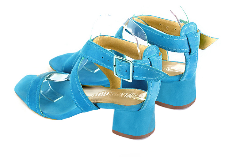 Turquoise blue women's fully open sandals, with crossed straps. Square toe. Low flare heels. Rear view - Florence KOOIJMAN